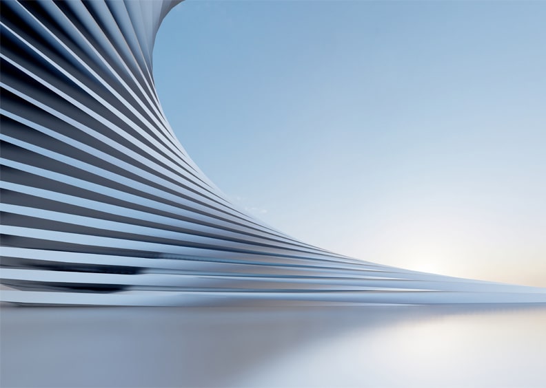 Futuristic, curving architectural structure with ribbed design against a clear blue sky and a low sun on the horizon.